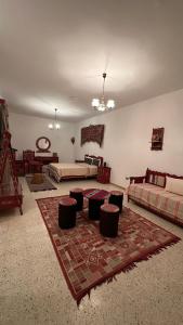 a large room with two beds and a rug at Dar morjana in Chott Meriem