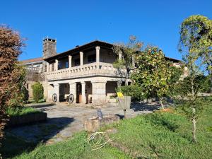 an old stone house with a tower on top of it at Pazo Carballo Hotel in Sampaio