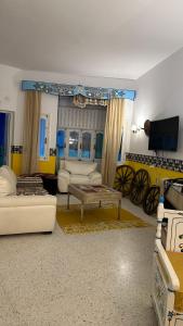 a living room with a couch and a table at Dar morjana in Chott Meriem +45 photos