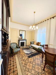 a living room with a couch and a fireplace at La Villa Bligny in Étretat
