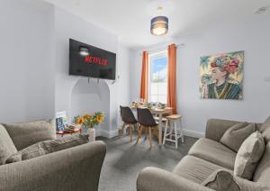 a living room with two couches and a dining room at 5-Bed Family & Group Stay Near Cricket Ground in Worcester