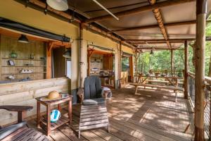 a house in the jungle with a table and chairs at Camping LA SERRE in Aigues-Vives