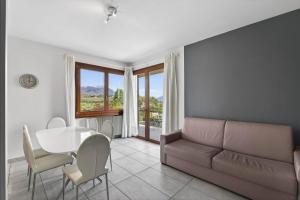 a living room with a couch and a table at Casa Veronica in Manerba del Garda