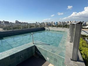 a swimming pool on the roof of a building at Studio JP Redenção in Porto Alegre