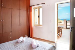 a bedroom with a bed with white towels on it at Oliva Mare I in Agia Fotia