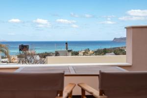 a balcony with a view of the ocean at Oliva Mare I in Agia Fotia