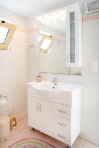 a bathroom with a sink and a mirror at Oliva Mare I in Agia Fotia +11 photos