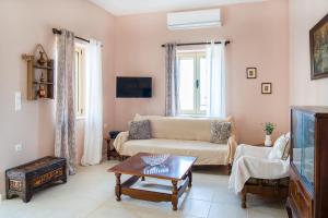 a living room with a couch and a table at Oliva Mare I in Agia Fotia