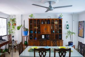 a dining room with a large wooden hutch at Casa de Mony in Santa Marta