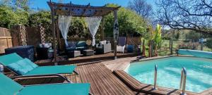 a backyard pool with chairs and a gazebo at Clos des Morillons in Vénérand