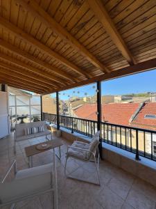 a balcony with a view of a roof at Dina Apartment in Ágios Rókkos