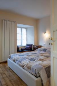 a bedroom with a large bed and a window at Oasi del relax in Scopello