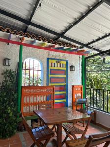 a patio with a wooden table and chairs and a building at Balcón Paisa SAS in Medellín
