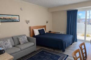 a living room with a bed and a couch at Courtyard Resort in Hyannis +17 photos