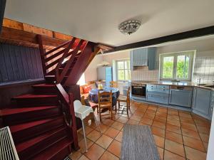 a kitchen with a staircase leading to a dining room at Die alte Waldkate - Windschief und mitten in der Natur in Kevelaer