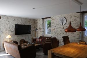 a living room with a couch and a table at L'EMPREINTE in Salavas +28 photos