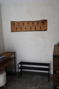 a wooden shelf on a wall with a bench at L'EMPREINTE in Salavas
