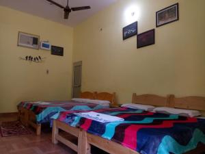 a bedroom with two beds in a room at corbett motel in Rāmnagar