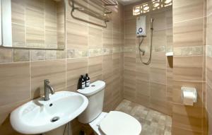 a bathroom with a toilet and a sink at Sea Place Pattaya Soi 7 in Pattaya