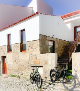 two bikes parked in front of a building at JUNKEIRA - Casa, Douro e Campo in Junqueira