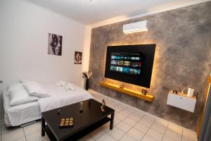 a bedroom with a bed and a tv on a wall at Ottoka in Kos