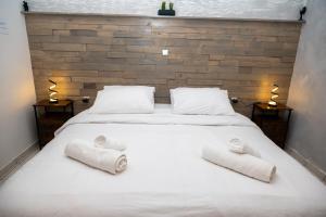a bedroom with a white bed with towels on it at Ottoka in Kos