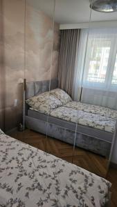 a bedroom with two beds and a window at Apartament Premium in Biała Podlaska