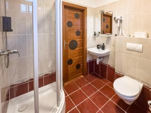 a bathroom with a toilet and a sink and a shower at Hotel Central in Ostrava