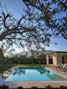 a swimming pool in front of a house at B&B El Rocol in Garda