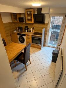 a small kitchen with a wooden table and a dining room at Ferienhaus in Marl +12 photos