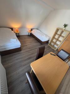 a room with a table and a bed and a desk at Ferienhaus in Marl