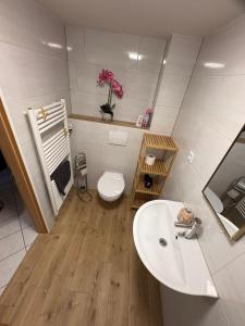a bathroom with a white sink and a toilet at Ferienhaus in Marl
