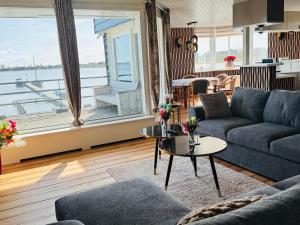 a living room with a couch and a table at Weromerie Premium Hotel and Apartment in Wormer