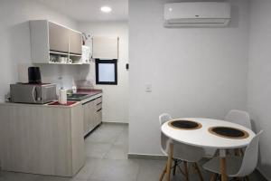 a kitchen with a small white table and chairs at México 1510 - Neuquén Centro in Neuquén