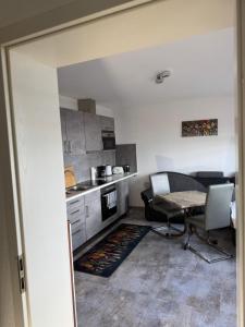 a kitchen with a table and a table and chairs at Hellwig Ferienwohnung 5 in Bernburg