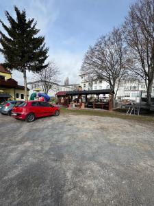 a parking lot with cars parked in front of a building at Hellwig Ferienwohnung 5 in Bernburg