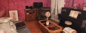 a living room with a room with a couch and a tv at La Genetouze in La Genétouze