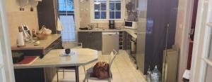 a kitchen with a counter and a table with a purse at La Genetouze in La Genétouze