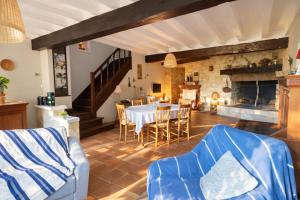 a living room with a table and a fireplace at Les rives enchantées in Loches