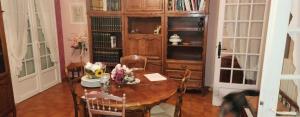 a dining room with a table with flowers on it at La Genetouze in La Genétouze