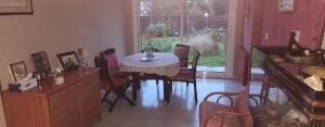 a dining room with a table and chairs in a room at La Genetouze in La Genétouze