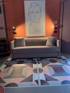 a living room with a couch and a drawing on the wall at Hotel Gianni Franzi in Vernazza