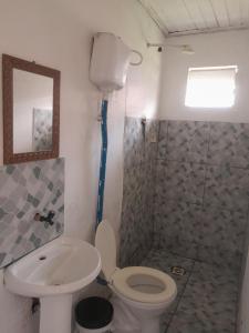 a bathroom with a toilet and a sink and a shower at Nosso Lar in Porto Velho