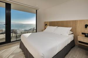 a bedroom with a large bed and a large window at Arka Hotel in Viña del Mar +66 photos
