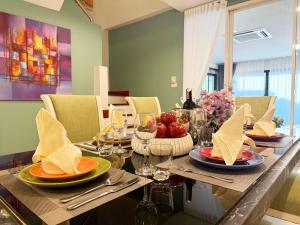 a dining room table with plates of food on it at THE MAISON Phuket in Ban Lo Long