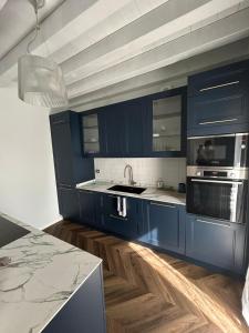 a kitchen with blue cabinets and a counter top at CasaVolta in Padova +2 photos