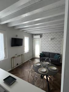 a living room with a table and a couch at CasaVolta in Padova