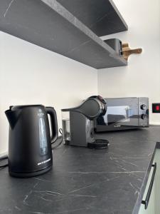 a appliance sitting on a counter in a kitchen at Sliema Penthouse 3 Ensuite Bedrooms Seaview - Zero55 in Sliema