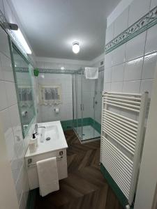a bathroom with a sink and a glass shower at CasaVolta in Padova