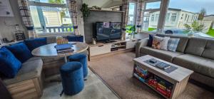 a living room with a couch and a tv at K&S at 1529 in Selsey